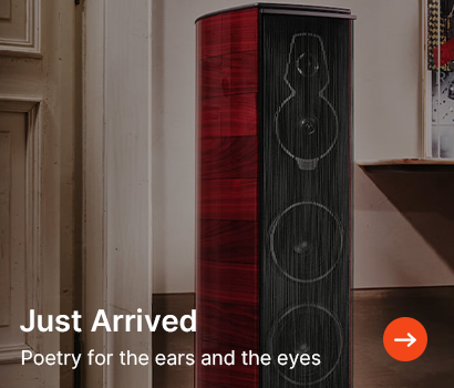 Red and black tower speaker in a stylish room setting. Text reads "Just Arrived: Poetry for the ears and the eyes," with an orange arrow icon.