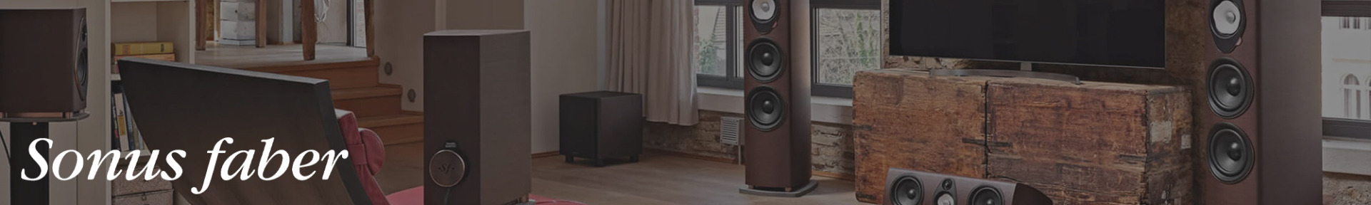 Modern living room featuring large Sonus faber speakers, hardwood floors, a rustic wood media console, and a large TV, creating a sophisticated audio setup.