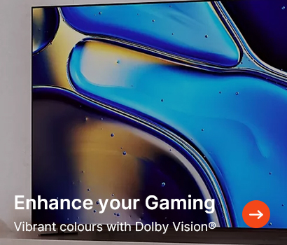 Close-up of a screen displaying a vibrant abstract design in blue and gold hues. The text reads "Enhance your Gaming" and "Vibrant colours with Dolby Vision®." An orange arrow icon is at the bottom.