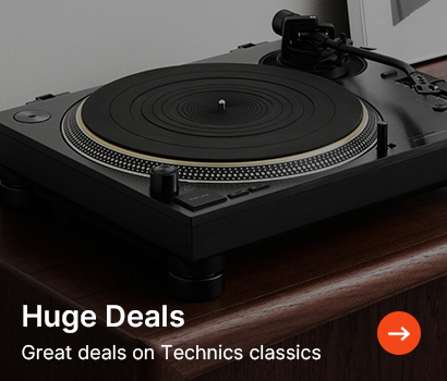 A turntable sits on a wooden surface with a modern, sleek design. Text reads "Huge Deals" with a red arrow button. Tone conveys excitement.