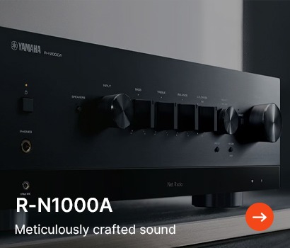 Sleek black Yamaha R-N1000A audio receiver with control knobs and ports, set against a minimalist background. Text reads "Meticulously crafted sound."