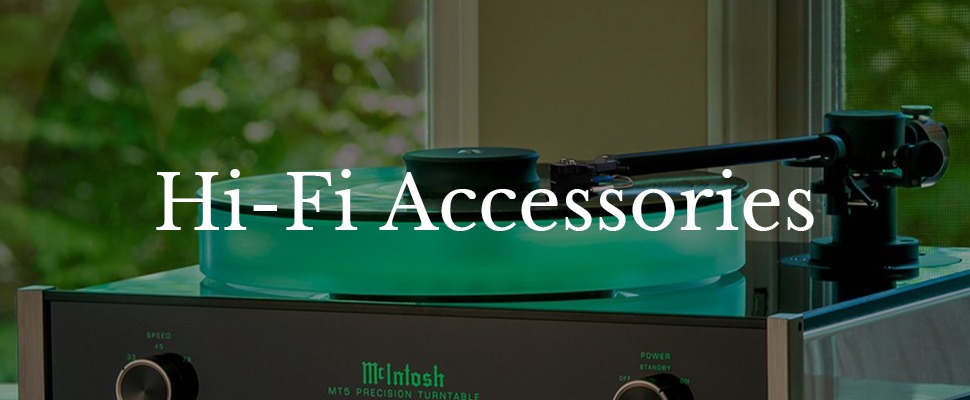 A modern turntable with a glowing green platter sits by a window, surrounded by lush greenery. The text "Hi-Fi Accessories" overlays the serene scene.