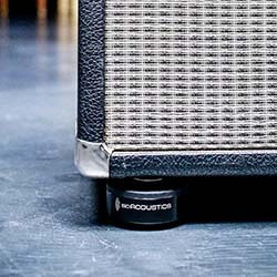 A sleek black audio component with a CD tray sits on a wooden cabinet against a neutral wall, conveying a minimalist and modern vibe.