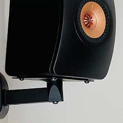 Wall-mounted black speaker with a copper-coloured cone, facing forward.