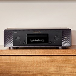 A black Marantz CD 50n sits on a wooden surface, displaying "Brandenburg Concerts" on its digital screen.