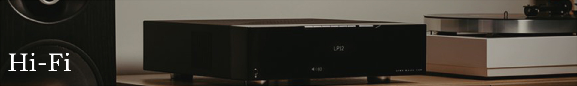 Sleek black Hi-Fi audio equipment sits on a wooden surface beside a white turntable. The scene conveys a modern, high-quality audio setup.