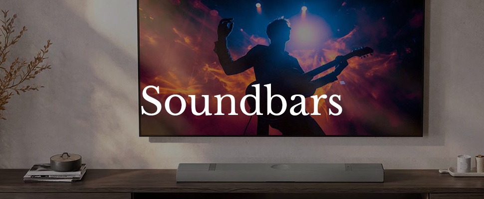 Modern living room with a flat-screen TV displaying a vibrant rock concert. A sleek soundbar sits below, enhancing the viewing experience.