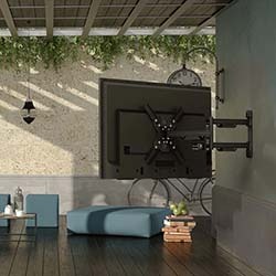 A black amplifier with knobs and buttons sits on a wooden console table in a modern room. 