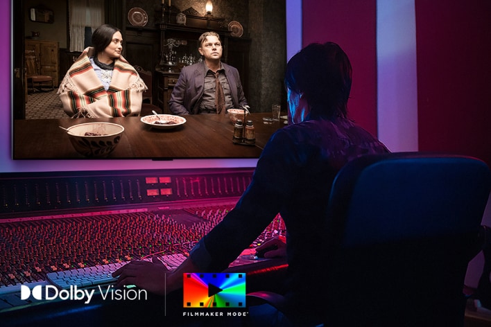 A director in front of a control panel editing the movie &quot;Killers of the Flower Moon&quot; on an LG OLED TV. In the bottom left, the Dolby Vision logo and FILMMAKER MODE logo.