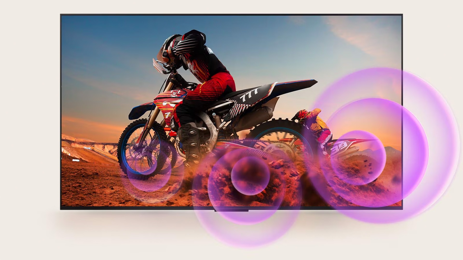 LG QNED TV depicts a man on a motorcycle with purple abstract circles coming out of the wheel to visualize sound emission. 