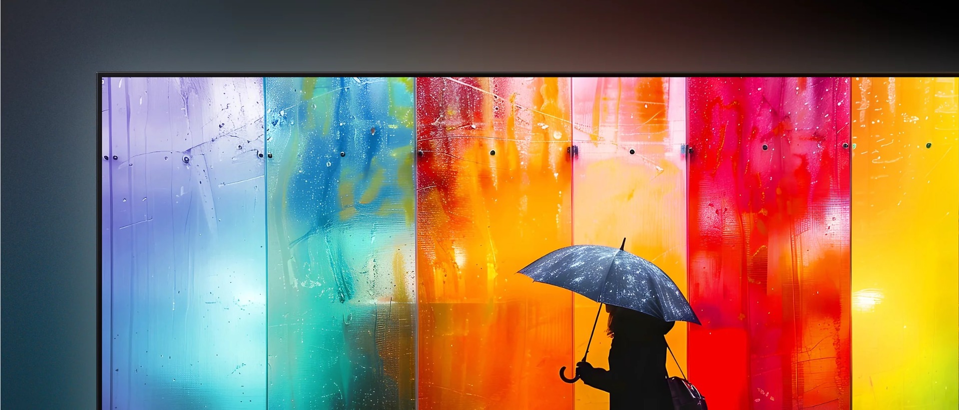 TV screen displaying a person with an umbrella in front of a vibrant, multi-coloured backdrop.