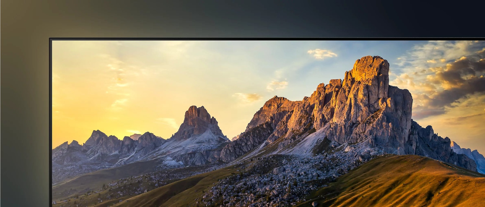 Detail of top left corner of TV showing screenshot of jagged mountains at sunrise