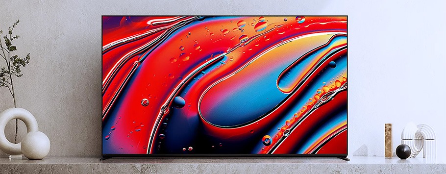 A sleek, modern TV displays vibrant abstract art with swirling red, blue, and orange hues. Minimalist décor surrounds, adding a calm, contemporary feel.