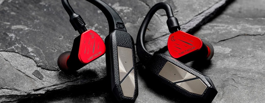 Red wireless earphones with a portable dac attached.