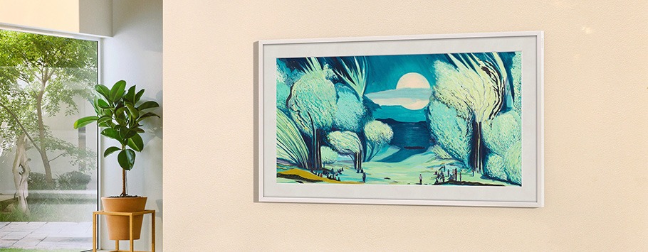 A framed landscape painting hangs on a beige wall, depicting a serene, moonlit forest in blue and green tones. A potted plant sits nearby, under soft natural light.