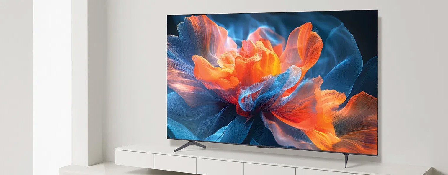 A sleek flat-screen TV displays a vivid, abstract flower with swirling blue and fiery orange petals, set in a minimalist white living room.